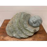 A stone sculpture of a sleeping person.