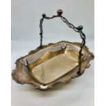 A silver bread basket on ball feet