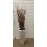 A tall contemporary vase with twisted willow