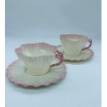 A pair of early Belleek Neptune cup and hexagon pattern saucers circa 1891 - 1926