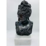 A Spelter Bust of a lady on a marble plinth.
