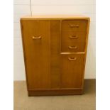 A G Plan tall boy with hanging cupboard, three drawers and lower cupboard (H122cm W88cm D46cm)