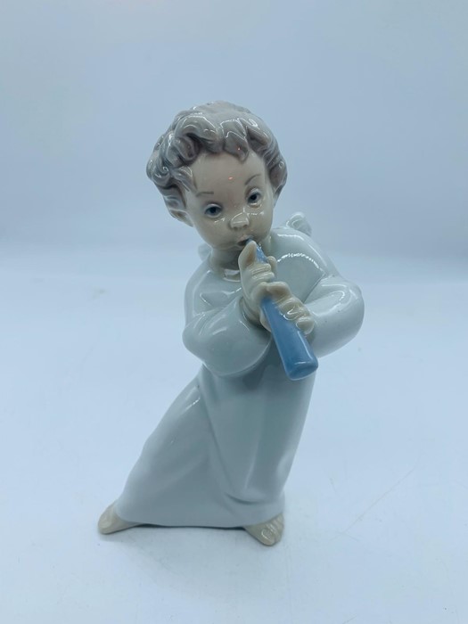 Lladro figure of an angel playing a flute