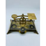 A brass postal scale