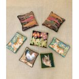 A selection of seven cushions, all velvet backed in a tapestry needle point style