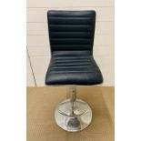 A hydraulic faux leather black stool