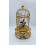 A Reuge music scribe Croix Automator of two song bird in a domed and gilded cage made in Switzerland