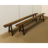 A pair of antique French fruitwood kitchen benches measuring 234cm in length