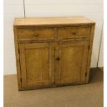 A pine cupboard with two drawers above two cupboard doors (H94cm D43cm W101cm) (please note there is