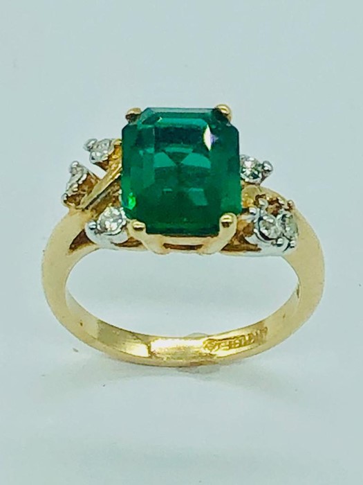 An 18ct gold Emerald and Diamond Ring (size M)