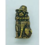 A brass vesta case in the form of a dog with a hat