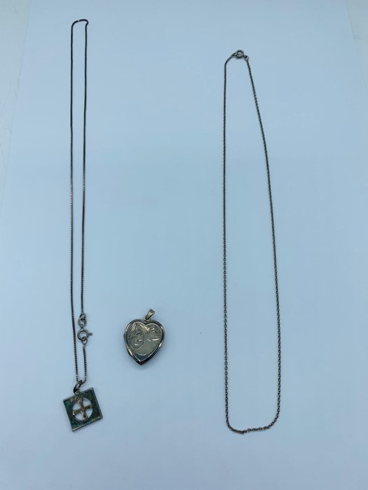 Two silver necklaces and one heart pendent