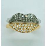 An 8ct white gold and rose gold pair of rings with pave diamonds in the shape of lips.