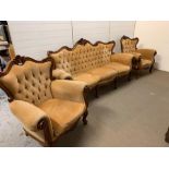 A large antique Biedermeier carved mahogany sofa with two chairs
