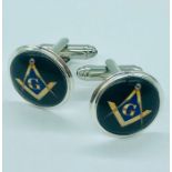 A pair of silver and enamel cufflinks with masonic symbols