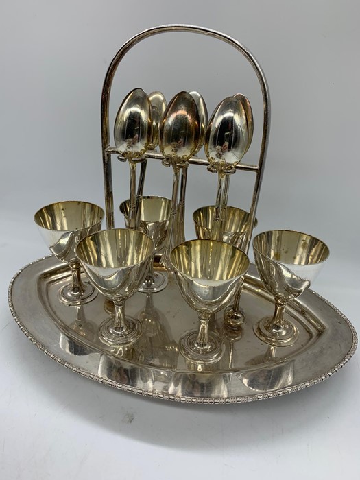 A silver plated egg serving set