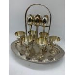 A silver plated egg serving set