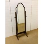 A full length cheval mirror with brass detailing to sides