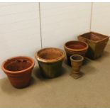 A collection of five terracotta garden pots