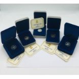 Five Isle of Man one pound coin presentation packs.