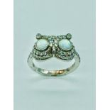 A silver CZ and opal dress ring in the form of an owl.