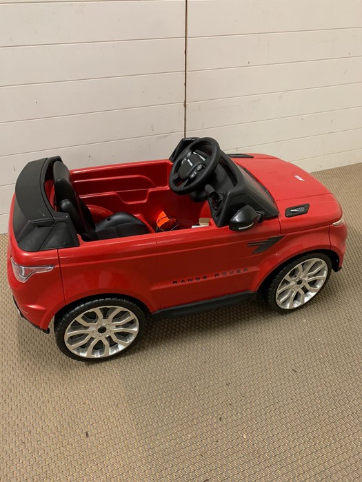A red Range Rover Sport style Child's ride on car with 6V-1A feber charger made by Famosa