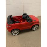 A red Range Rover Sport style Child's ride on car with 6V-1A feber charger made by Famosa