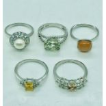 A collection of silver rings, various sizes and fashions.