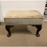 A footstool with cushion top.