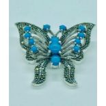 A silver and turquoise Butterfly brooch