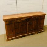 An Indian hardwood sideboard with three cupboards and a middle draw (H87cm D39cm W160cm)