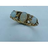 A Three Stone Opal ring on a 9ct yellow gold mount.