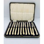 A Boxed set of twelve butter knives with silver mounts