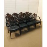 A set of twelve shield-back with central oval panel dining chairs with black leather seats and