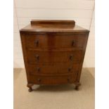 A bow fronted small four drawer chest of drawers.