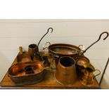 A selection of copper ware including cider ladles, copper and brass banded jug