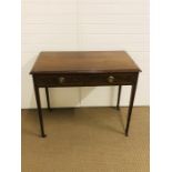 A rectangular hall table on tapered legs with two drawers and brass pull ring handles and string