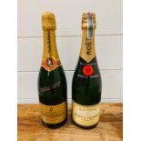 A Bottle of Moet and Chandon Champagne and a bottle of Charles Heidsieck Champagne.