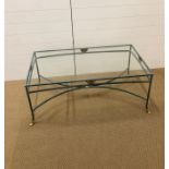 A decorative iron Verdigris style coffee table with glass top and brass fan detailing and brass