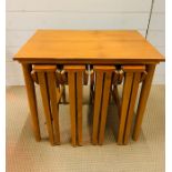 A Mid Century small table with four folding chairs nested.