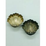 A pair of silver, hallmarked shell shaped salts