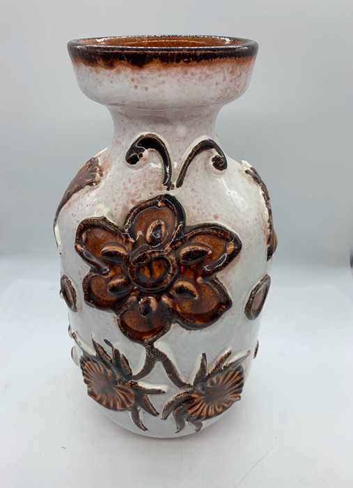 A Studio Pottery vase with a floral theme.