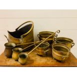 A selection of brass handle pots and spirit ladles