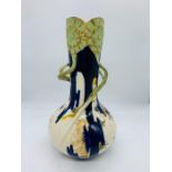 A porcelain vase with green gilt flower design