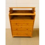 A pine baby changing unit with drawers under.