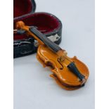 A Miniature violin cased with bow