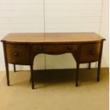 A Sheraton style butlers sideboard with two deep drawers either side, one with an insert, a middle