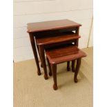A set of three high gloss Rosewood style nest of tables