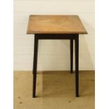 A square topped occasional table with tapered legs
