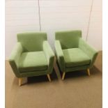 A pair of modern green upholstered armchairs with light oak legs AF